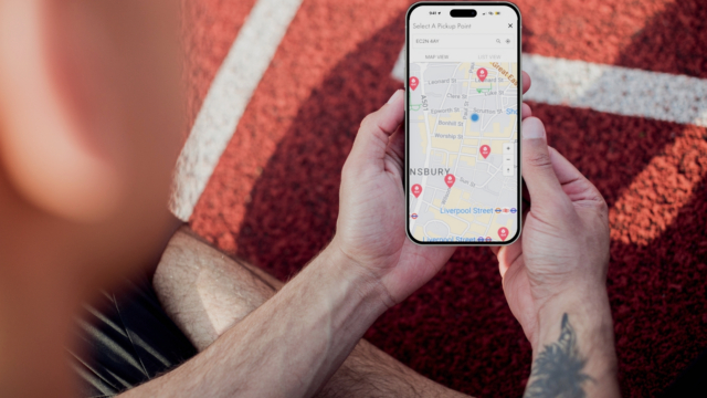 Person using HubBox mobile map to select out-of-home delivery at checkout